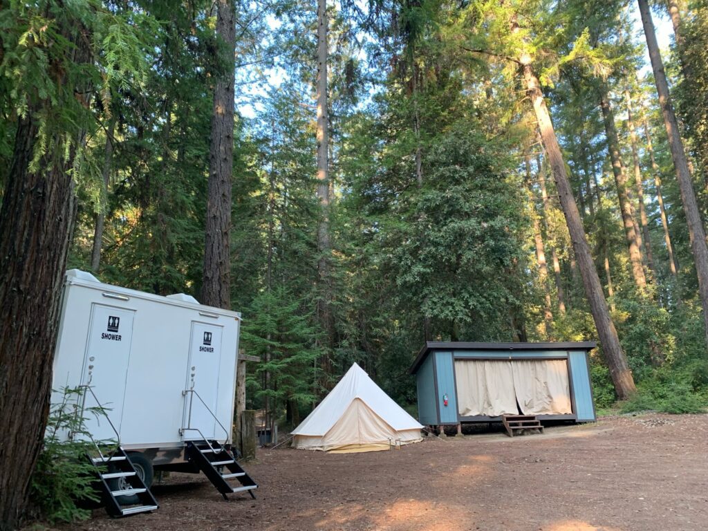 2-station private shower trailer at a wooded glamping site near a bell tent, The Lavatory Los Angeles