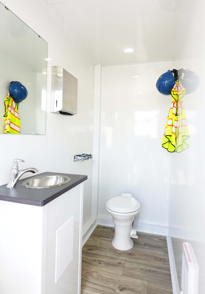 Private stall with sink, toilet and hooks holding the work crew's hard hats and safety vests, The Lavatory Los Angeles