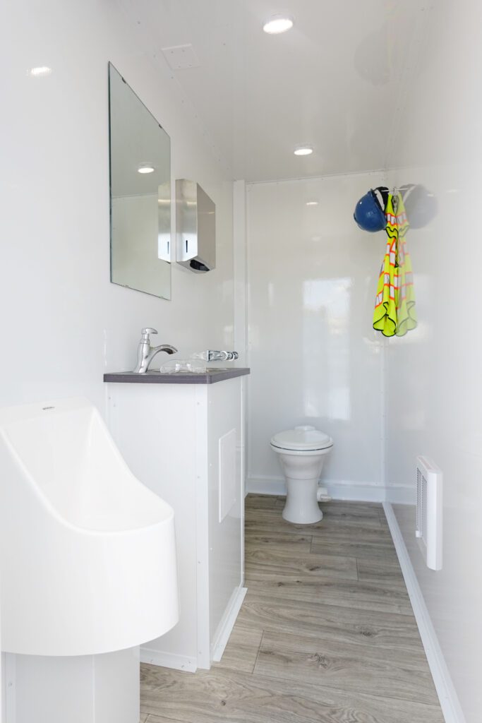 Private stall with urinal, vanity sink and toilet inside an 8-station private stall deluxe trailer, The Lavatory Los Angeles