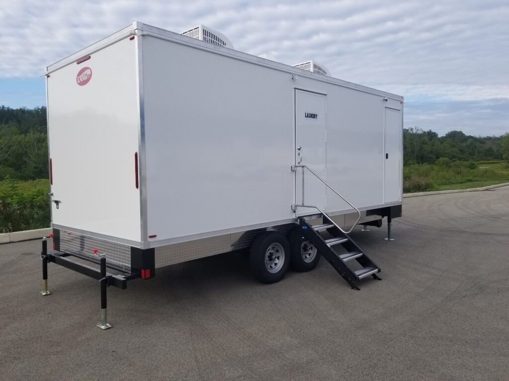 Side view of the 8-station laundry trailer with its laundry door and fold-down entry steps, The Lavatory Los Angeles