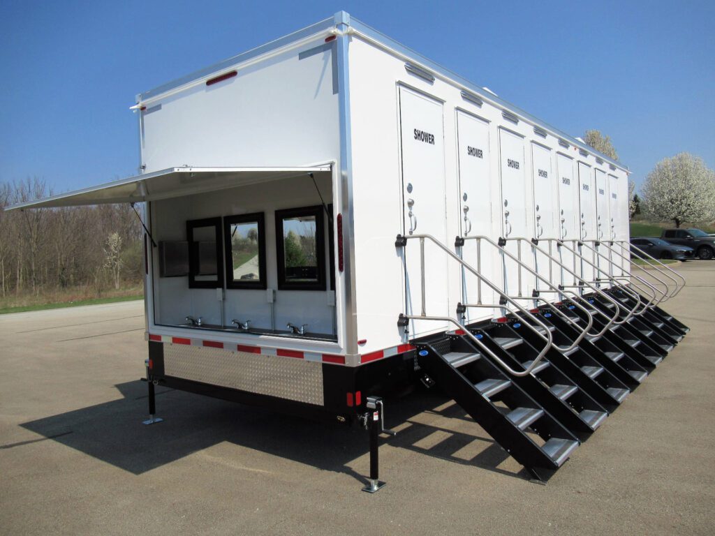 8-station private shower trailer with an open sink awning and steps at every door, The Lavatory Los Angeles
