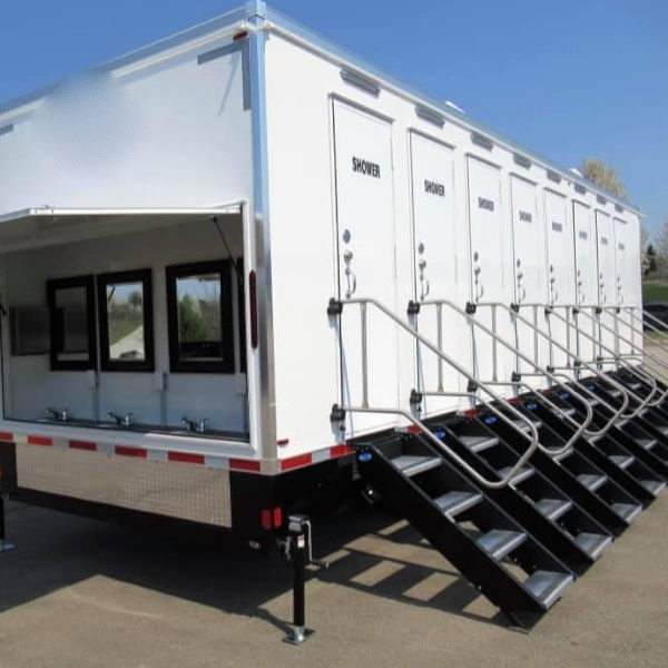 8-station private shower trailer with an open sink awning and steps at every door, The Lavatory Los Angeles
