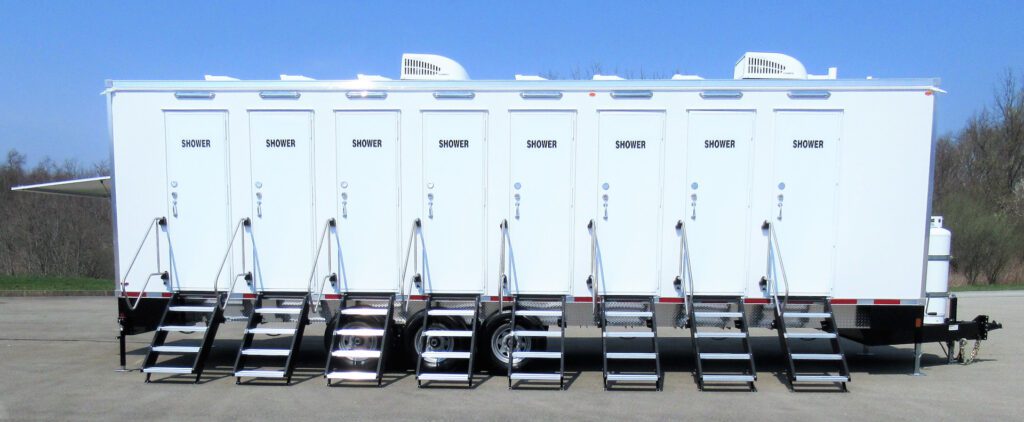 Side view of an 8-station private shower trailer with eight shower doors and steps, The Lavatory Los Angeles