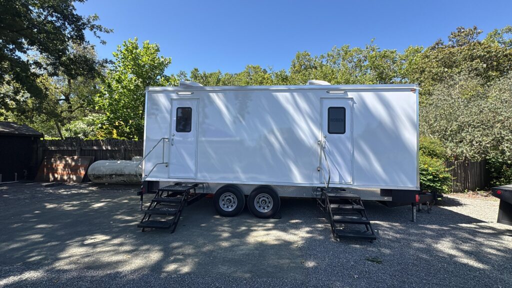 9-station deluxe bathroom trailer on a shaded gravel drive at a private estate, The Lavatory Los Angeles