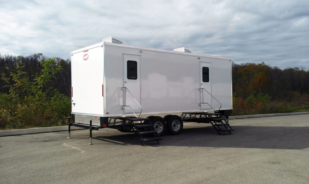 9-station luxury bathroom trailer with two entry doors and steps on a paved lot, The Lavatory Los Angeles