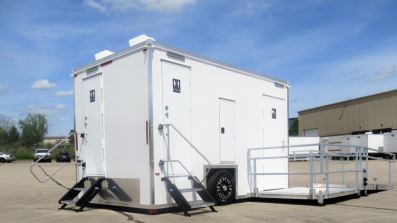ADA plus 2 trailer with entry steps and a platform with handrails on a paved lot, The Lavatory Los Angeles