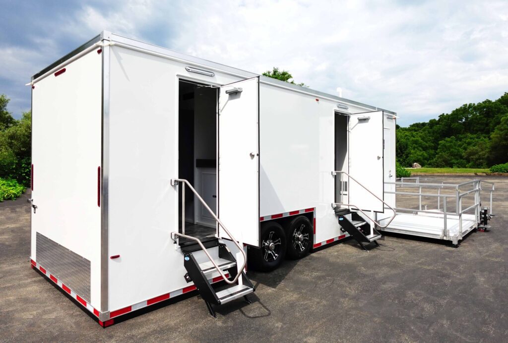 ADA plus 6 bathroom trailer with doors open, entry steps and a deployed wheelchair ramp, The Lavatory Los Angeles