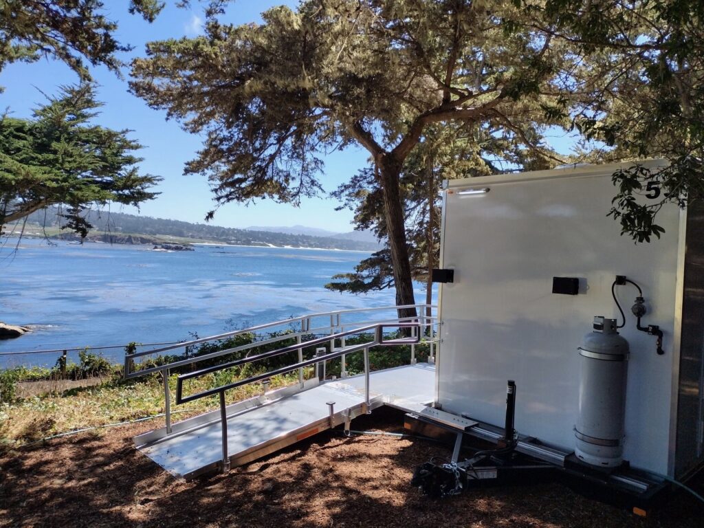 Accessible combo trailer ramp and railing set on a wooded bluff above the ocean and coastline, The Lavatory Los Angeles