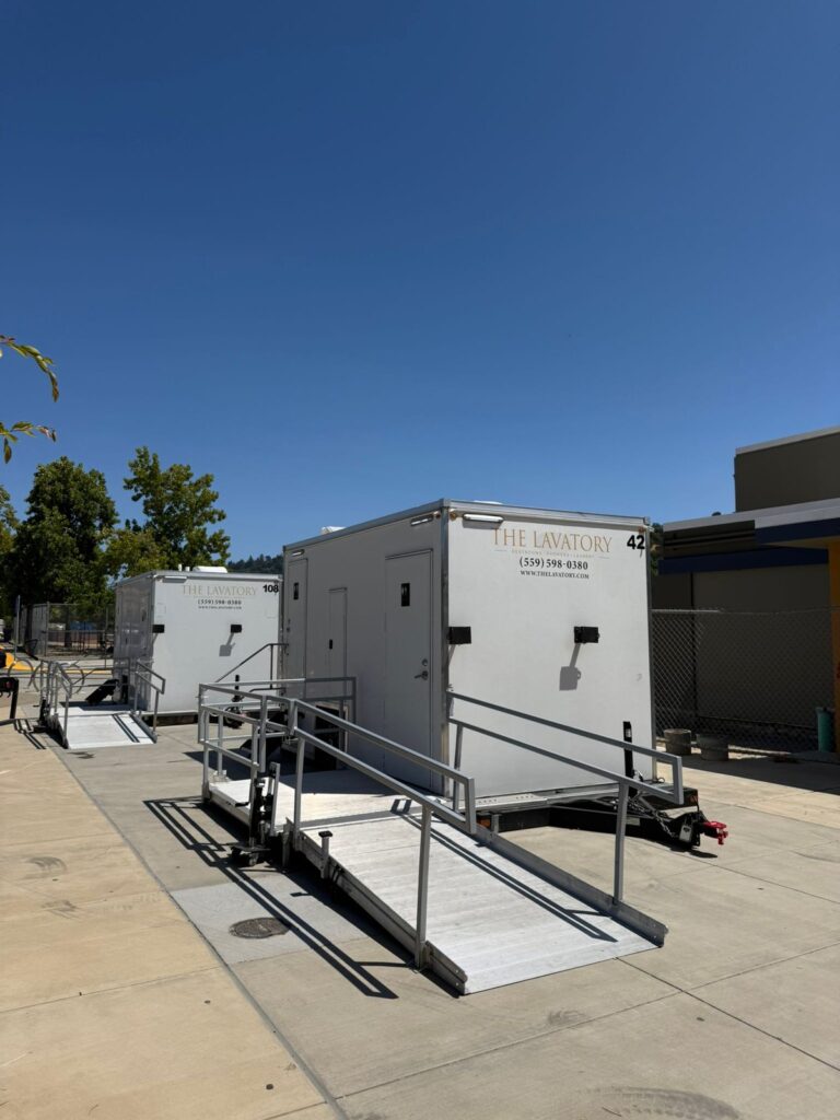 ADA plus 2 bathroom trailers with railed ramps on a high school walkway for a graduation, The Lavatory Los Angeles