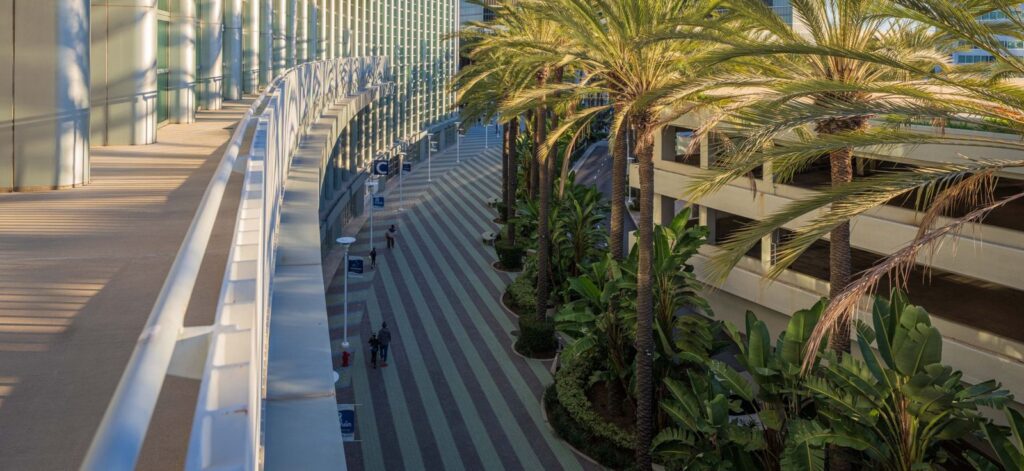 Curved glass facade and palm-lined walkway of the Anaheim Convention Center in Anaheim, California, The Lavatory Los Angeles