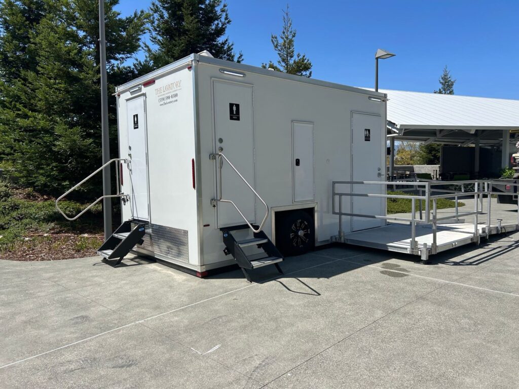 Luxury bathroom trailer with entry steps and a ramp landing on a corporate campus walkway, The Lavatory Los Angeles