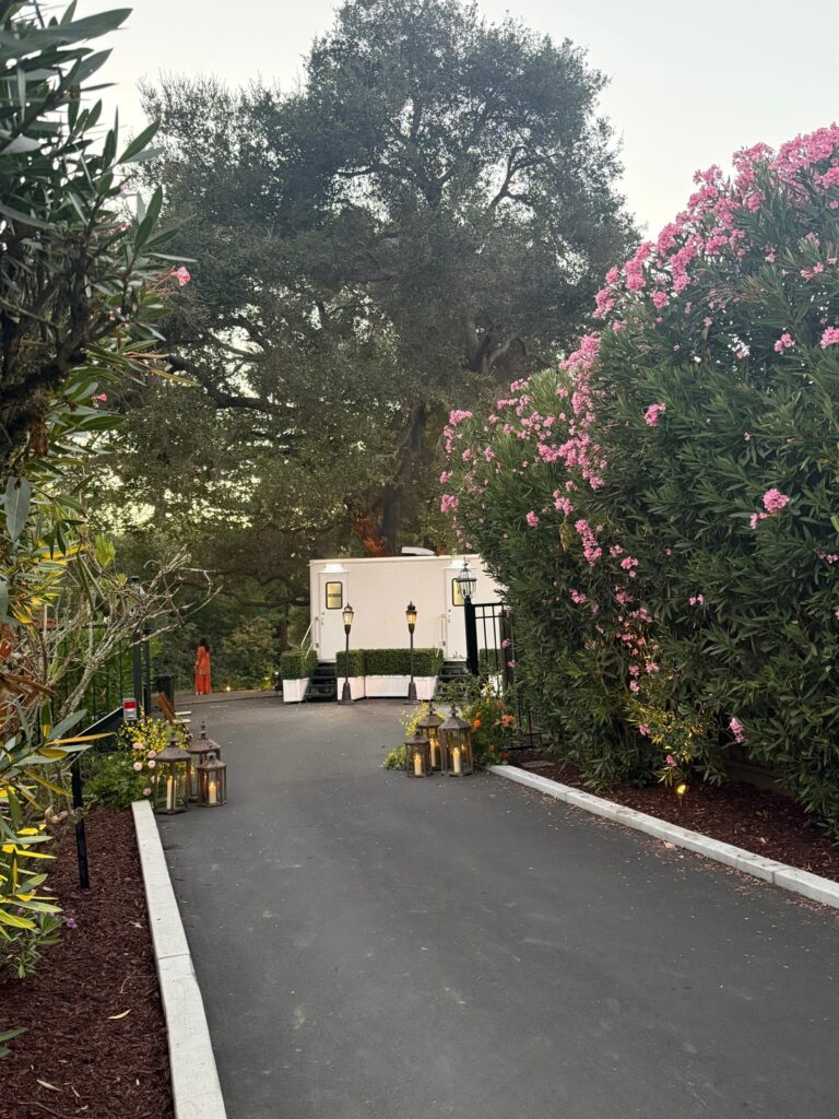 3-station bathroom trailer at the end of a lantern-lined drive with pink oleanders for a wedding, The Lavatory Los Angeles