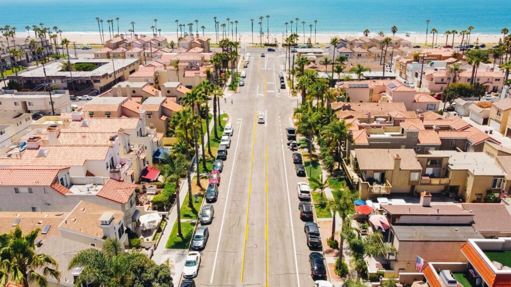Aerial view of a palm-lined street running down to the beach in Huntington Beach, The Lavatory Los Angeles