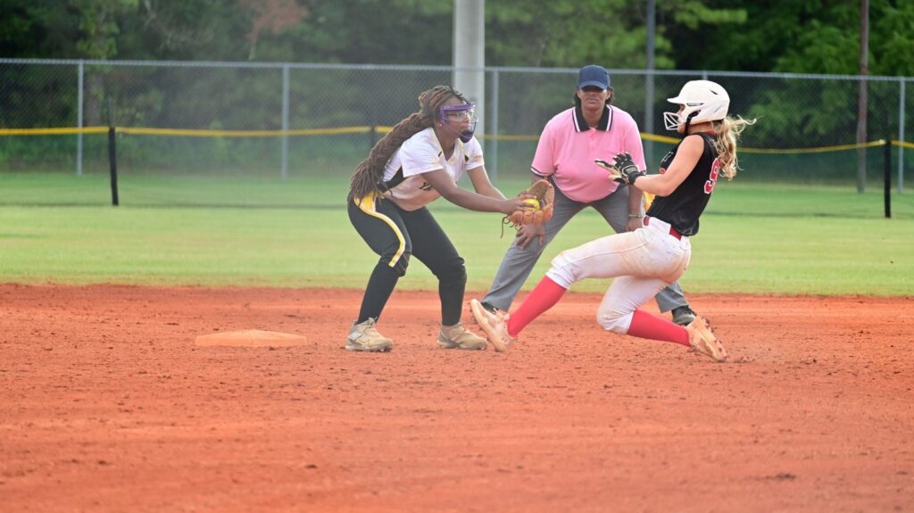 Youth softball team players and an umpire at second base during tournament play, The Lavatory Los Angeles