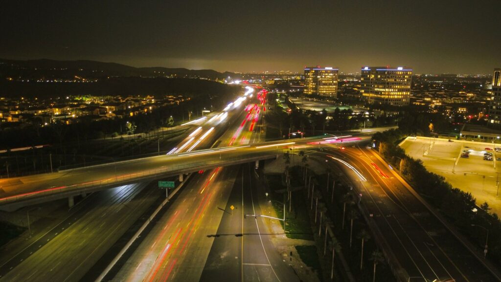 Freeway traffic and office towers at night in Irvine, CA, The Lavatory Los Angeles