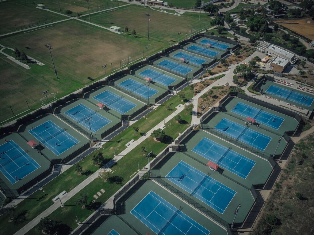 Aerial view of rows of tennis courts at the Great Park sports complex in Irvine, CA, The Lavatory Los Angeles