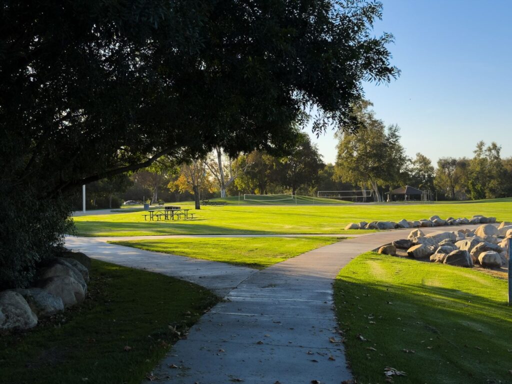 Walking path through a grassy park at golden hour in Irvine, CA, The Lavatory Los Angeles