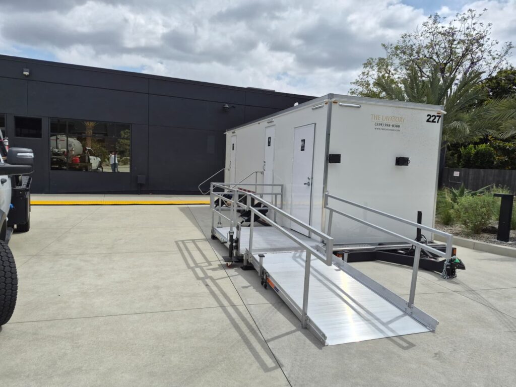ADA plus 2 bathroom trailer with a long railed wheelchair ramp in a commercial courtyard, The Lavatory Los Angeles
