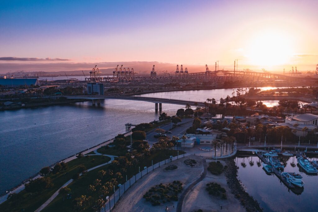 Port of Long Beach cranes and the harbor bridges at sunset seen from the Downtown Long Beach waterfront, The Lavatory Los Angeles