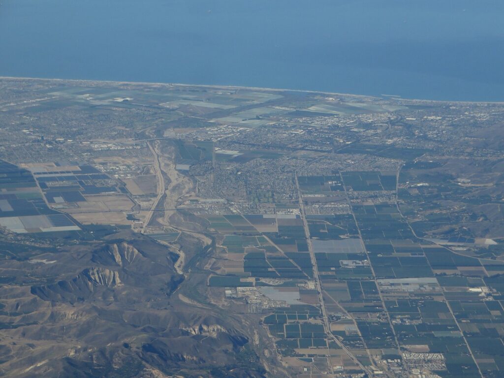 Aerial view of farm fields, neighborhoods and the Pacific coast across the Oxnard Plain in Oxnard, CA, The Lavatory Los Angeles