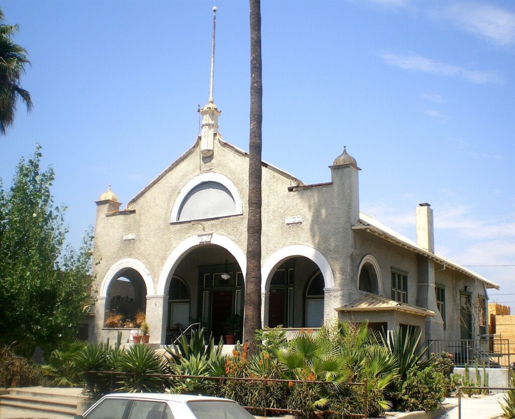 1904 stucco building with three front arches and a tall palm in the Edison Historic District of Pomona, CA, The Lavatory Los Angeles
