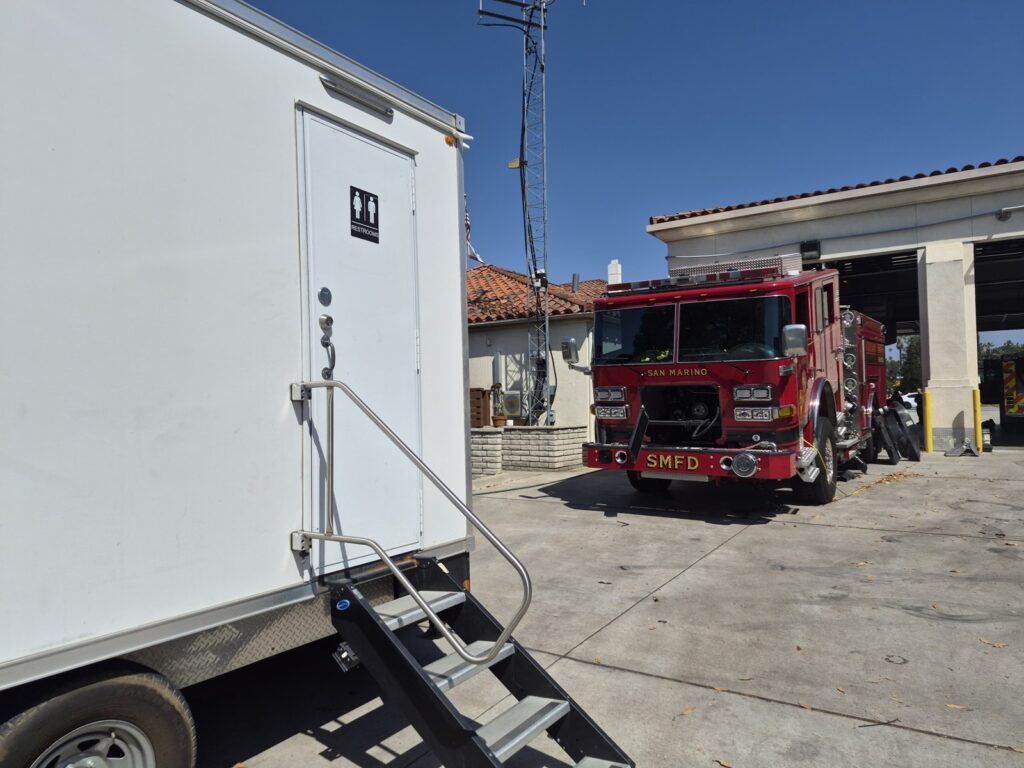 Bathroom trailer parked beside a fire engine at a San Marino fire station, The Lavatory Los Angeles