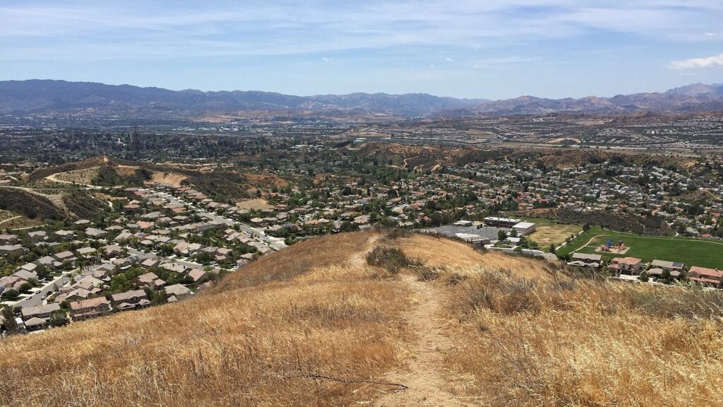 Hilltop trail looking across Santa Clarita neighborhoods toward the valley floor and mountains, Santa Clarita, CA, The Lavatory Los Angeles