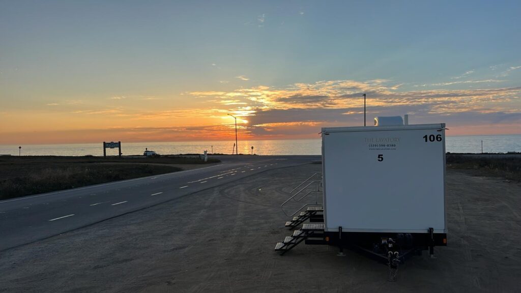 5-station bathroom trailer in a coastal parking area at sunset, The Lavatory Los Angeles