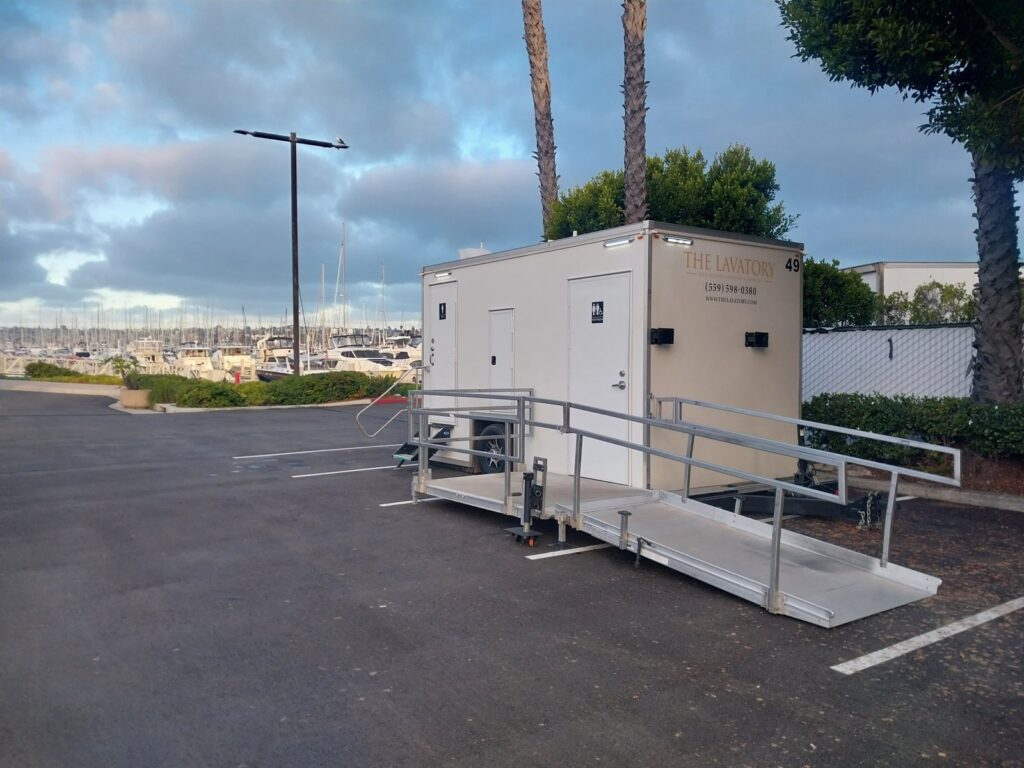 ADA plus 2 bathroom trailer with a railed wheelchair ramp in a parking lot near a marina, The Lavatory Los Angeles