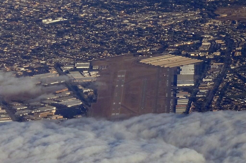 Aerial view of Zamperini Field, the Torrance Municipal Airport, with hangars and city around it, The Lavatory Los Angeles